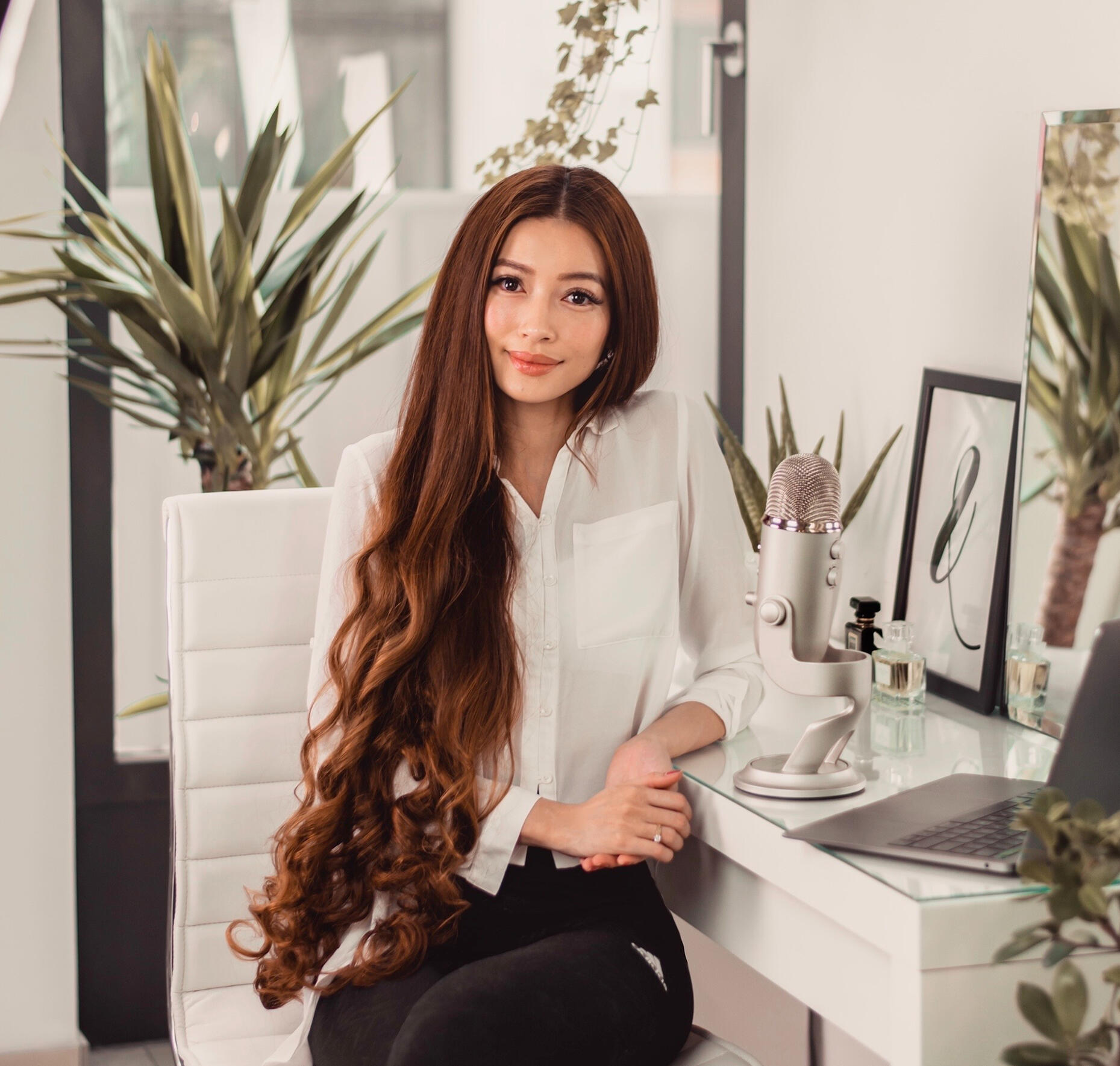 Sarah Tran, founder and CEO of Holiniq, in a natural-light portrait with long hair.